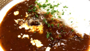 Japanese Golden Curry Rice served with beef mushrooms fresh parsley and a cream drizzle