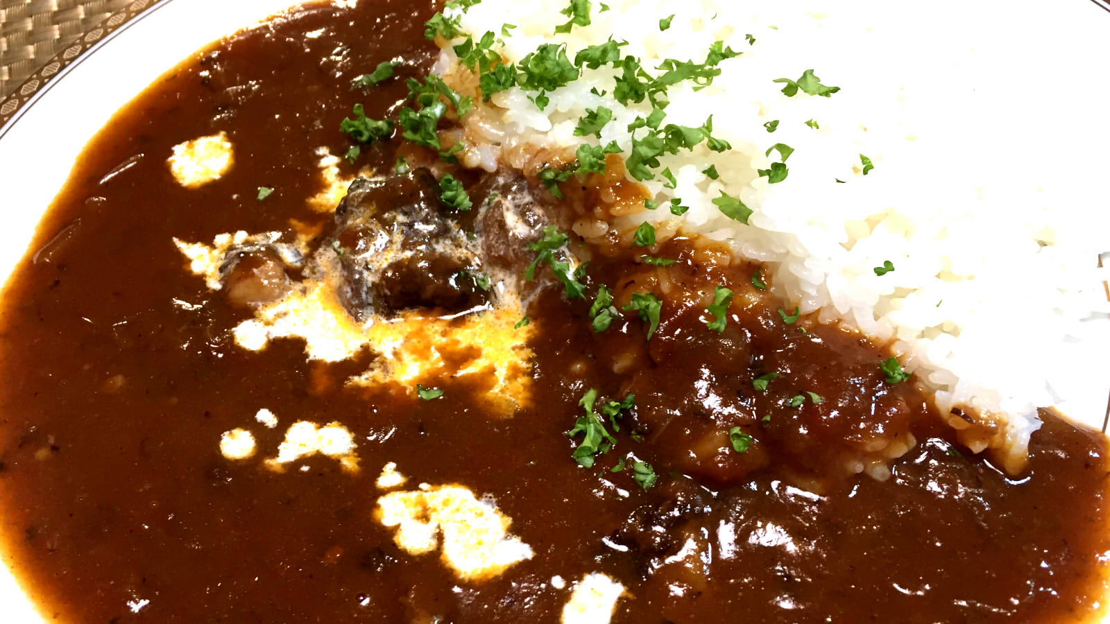 Japanese Golden Curry Rice served with beef mushrooms fresh parsley and a cream drizzle