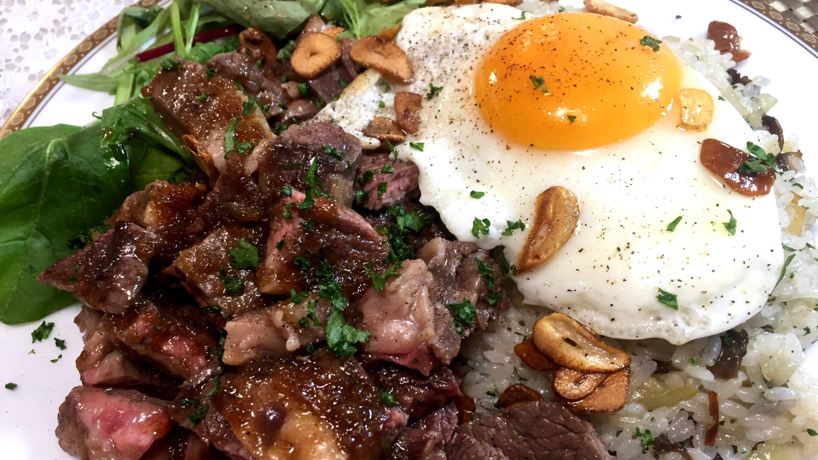 Tokyo style teppanyaki hibachi steak cubes with garlic pilaf fried egg and steak shoyu sauce